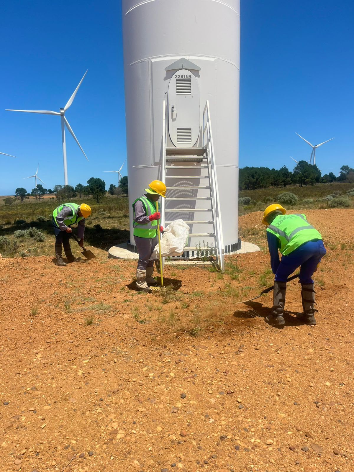 Zumbe Services team clearing grounds around a wind turbine